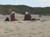 Mooi is het oudere echtpaar op het duin, donker gekleurd door de zon met hun afstekende witte haren.
